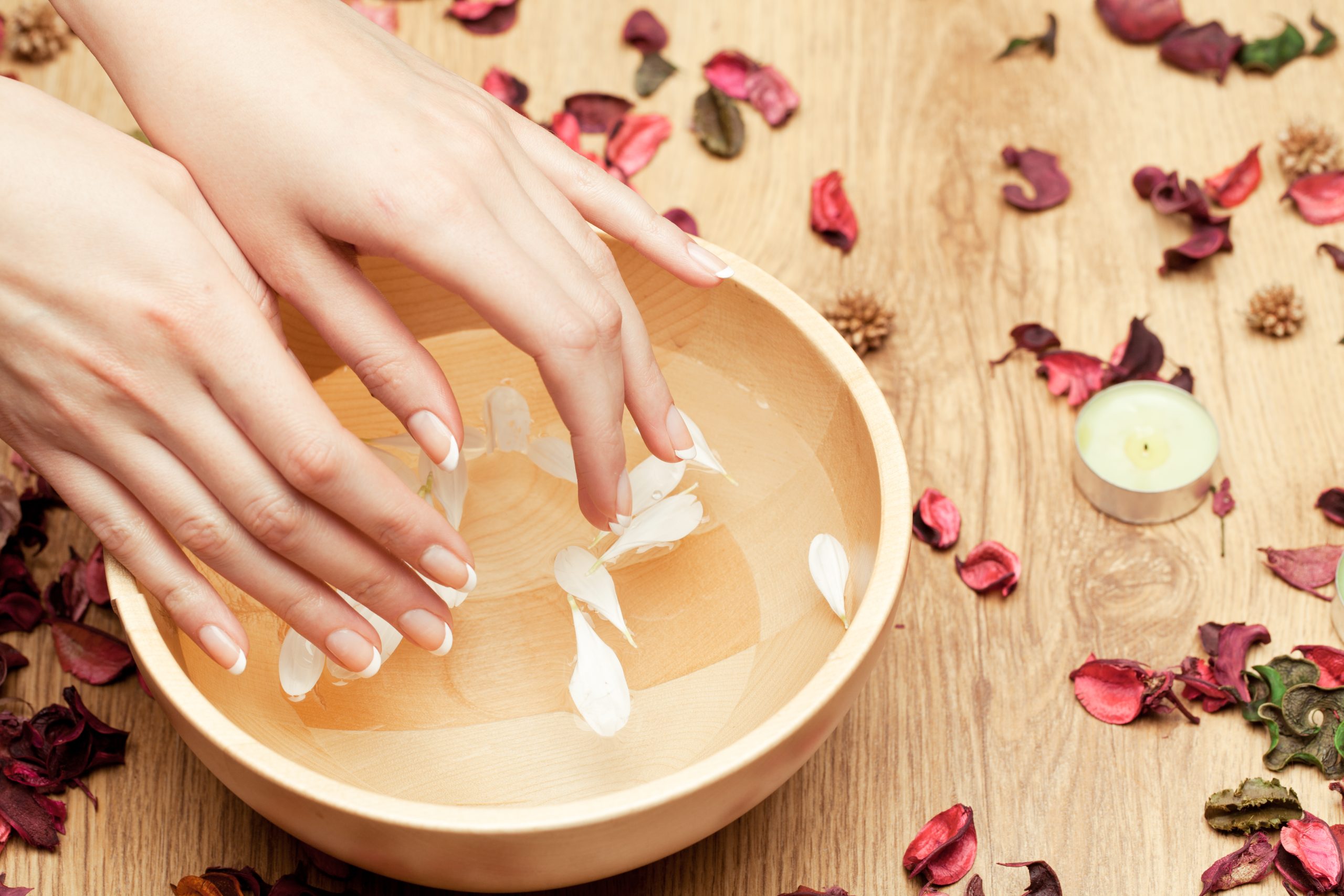 Hands relaxing in a floral soak